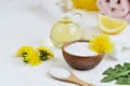 Natural ingredients for homemade body salt scrub with dandelion flowers, lemon, honey and olive oil Royalty Free Stock Photo