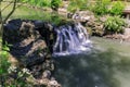 Natural inviting landscape view in botanical garden with a small water fall