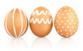 Natural isolated eggs. Three Easter brown eggs decorated with patterns of white paint Royalty Free Stock Photo