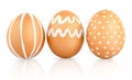 Natural isolated eggs. Three Easter brown eggs decorated with patterns of white paint