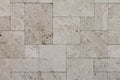 Natural Italian stone. Smooth travertine surface. A sample of wall cladding with natural stone.