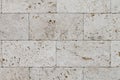 Natural Italian stone. Smooth travertine surface. A sample of wall cladding with natural stone. Background