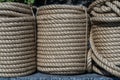 Natural jute hemp rope rolled into a coil, closeup. Brown spool of linen rope texture on the background