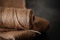 Natural jute twine roll, burlap on black background. Supplies and tools for handmade hobby leisure Royalty Free Stock Photo