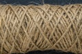 Natural jute twine skein, closeup. Spool of linen rope texture on background