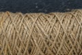 Natural jute twine skein, closeup. Spool of linen rope texture on background