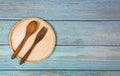 Natural kitchen tools wood products / Kitchen utensils with wooden plate spoon and fork in the dinner table background Royalty Free Stock Photo