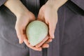 Natural konjac sponge in a female hands for deep cleanse and exfoliate skin.