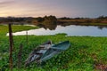 Natural landscape with boats in the water at sunset. Amazing lake with small artisanal fishing boats. Sunrise light reflected in w