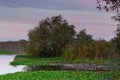 Natural landscape with boats in the water at sunset. Amazing lake with small artisanal fishing boats. Sunrise light reflected in w Royalty Free Stock Photo