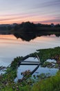 Natural landscape with boats in the water at sunset. Amazing lake with small artisanal fishing boats. Sunrise light reflected in w Royalty Free Stock Photo