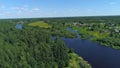 Natural landscape with green trees, wide river, and green field. Shot. Aerial view of summer landscape with forest Royalty Free Stock Photo