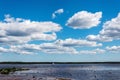 Natural landscape with high cloudy blue sky over the lake water Royalty Free Stock Photo