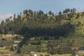 Natural landscape of the Mexican countryside, you can see a hill with trees and some houses of a town called Almoloya de Juarez