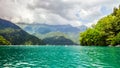 Natural landscape. Panorama view of the lake Small Ritsa. Trees reflecting in the blue from lapis lazuli water. Ritsa National Par Royalty Free Stock Photo