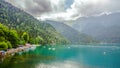 Natural landscape. Panorama view of the lake Small Ritsa. Trees reflecting in the blue from lapis lazuli water. Ritsa National Par Royalty Free Stock Photo