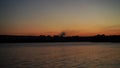 Natural landscape with sunset over the river and city.