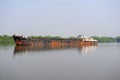 Natural landscape. Water transport. Barge floating on the river. Cargo ship, Mandovi River in Goa, India Royalty Free Stock Photo