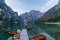 Natural landscapes of the lake Braies Lago di Braies with morning fog and reflection of the mountain peak in Dolomites, Italy