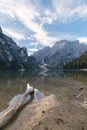 Natural landscapes of the lake Braies Lago di Braies with morning fog and reflection of the mountain peak in Dolomites, Italy