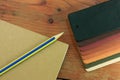 Natural leather samples variety shades of colors with notebook and pencil on wood table, designer concept. Royalty Free Stock Photo