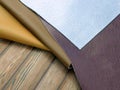 Natural leather textures samples on brown wooden background Royalty Free Stock Photo