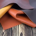 Natural leather textures samples on dark wooden background Royalty Free Stock Photo