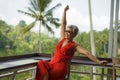 Attractive and happy Asian Indonesian middle aged woman with grey hair relaxed chilling cheerful and carefree and tropical