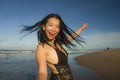 Natural lifestyle portrait of young attractive and happy Asian Korean woman in swimsuit walking on beautiful beach paradise Royalty Free Stock Photo