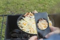 natural light. barbecue. a frying pan is used for cooking. fire. firewood. the girl takes pictures on the phone Royalty Free Stock Photo