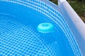 natural light. frame pool. a container with solid tablets floats in the pool for disinfection Royalty Free Stock Photo