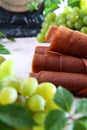 Natural light grape marshmallow is rolled into a tube. Natural bioproduct without preservatives. Vintage scales. Food for