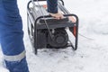 natural light. shallow depth of field. snow. an autonomous generator for generating electricity. close-up Royalty Free Stock Photo