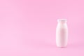 Natural liquid yogurt with probiotics in small plastic bottles on pink background. Healthy, balanced diet food, healthy breakfast