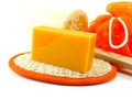 Natural Luffa sponge with orange soap Royalty Free Stock Photo