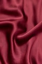 Natural magenta red silk fabric with folds texture Royalty Free Stock Photo
