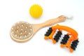 Natural massage, wooden brush and yellow ball with spikes and masseur with wheels for body care on a white background close-up.