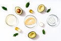 Natural medicine glass labware, petri dishes, cream jars, scrub, aromatic oils. Avocado oil natural cosmetic background