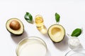 Natural medicine glass labware, petri dishes, cream jars, scrub, aromatic oils. Avocado oil natural cosmetic background