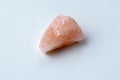 Natural mineral crystal of rose quartz gemstone. Natural rose quartz crystal. White background Royalty Free Stock Photo