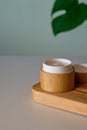 Natural moisturizing cream in eco-friendly bamboo jar. Organic skin care product packaging design