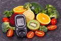 Natural nutritious fruits with vegetables and glucometer with result of sugar level, diabetes and healthy lifestyles concept