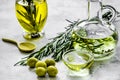 Natural oils concept with fresh olives on table background
