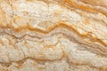 Natural onyx marble texture features a captivating wavy pattern, showcasing warm beige and brown hues, making it suitable for Royalty Free Stock Photo