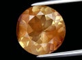 Natural orange andesine gem on the background Royalty Free Stock Photo