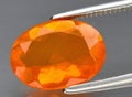 Natural orange fire opal gem on the background Royalty Free Stock Photo