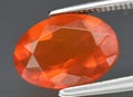Natural orange fire opal gem on the background Royalty Free Stock Photo