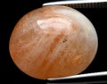 natural orange sunstone gem on the background Royalty Free Stock Photo