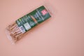 Natural organic breadsticks in a plastic package isolated on pink background