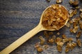 Natural organic brown crystal rock sugar in wooden spoon over wooden background Royalty Free Stock Photo